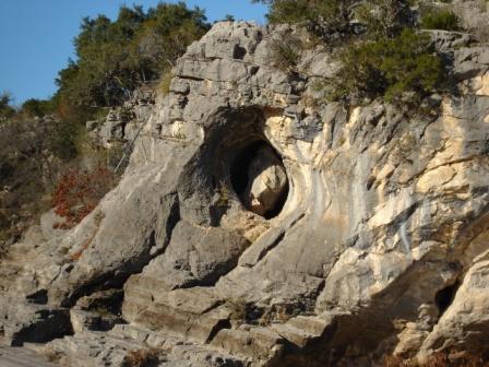 A massive boulder trapped in the cliff.
