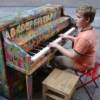 Hayden playing a street piano in the financial district